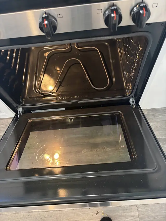 The same oven after a deep clean, glass door and racks spotless