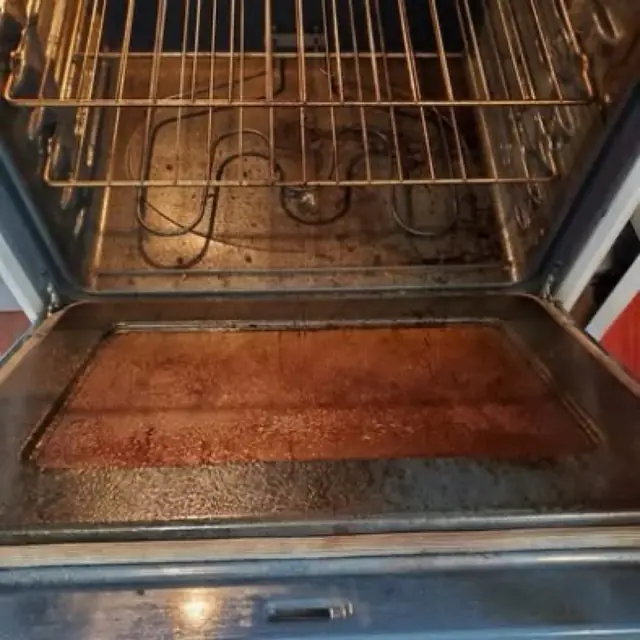 A greasy oven interior before a deep clean